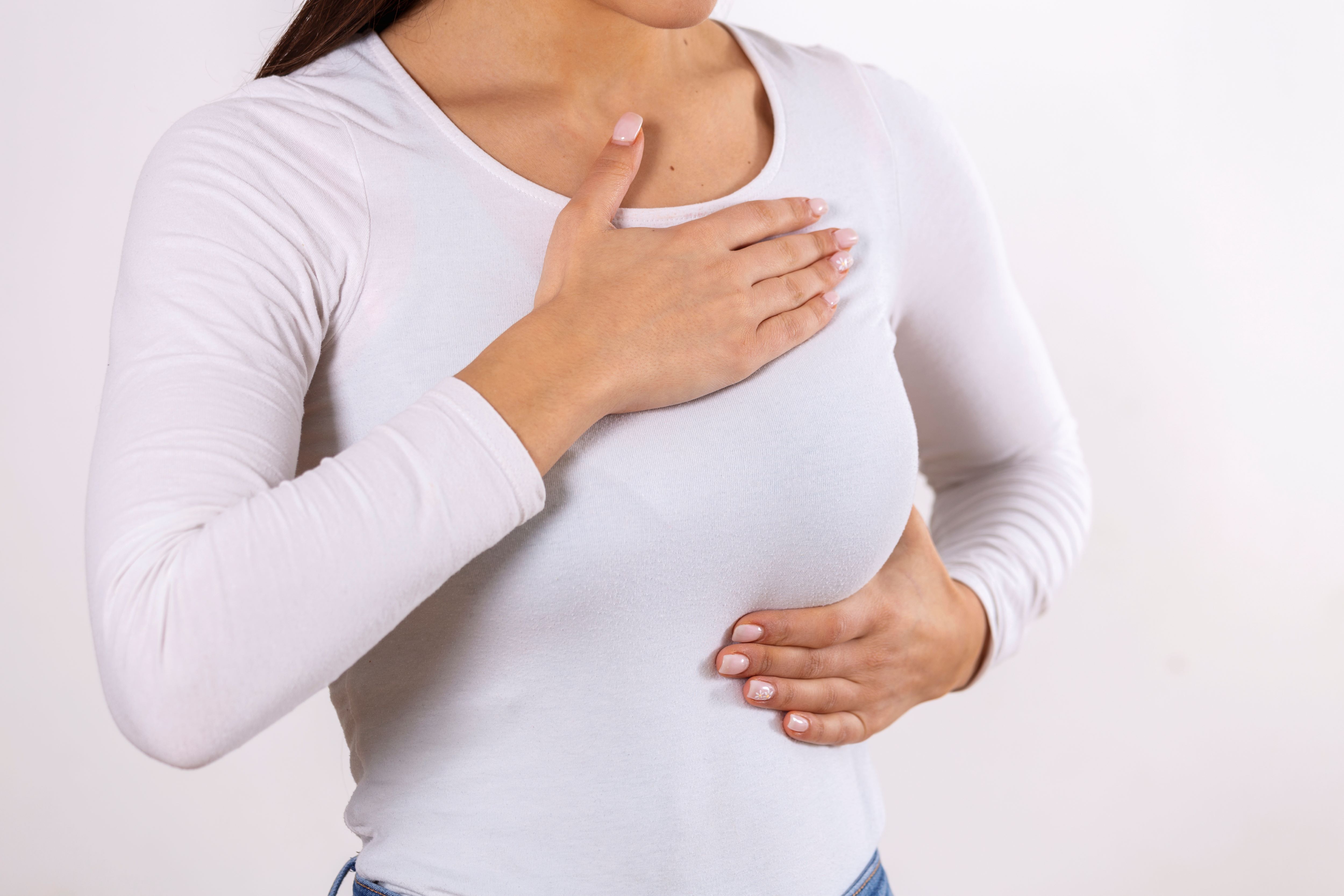 1785219250 Woman Hand Checking Lumps Her Breast Signs Breast Cancer Gray Background Healthcare Concept Closeup Woman S Hand Breast Showing Cancer Symptom 1