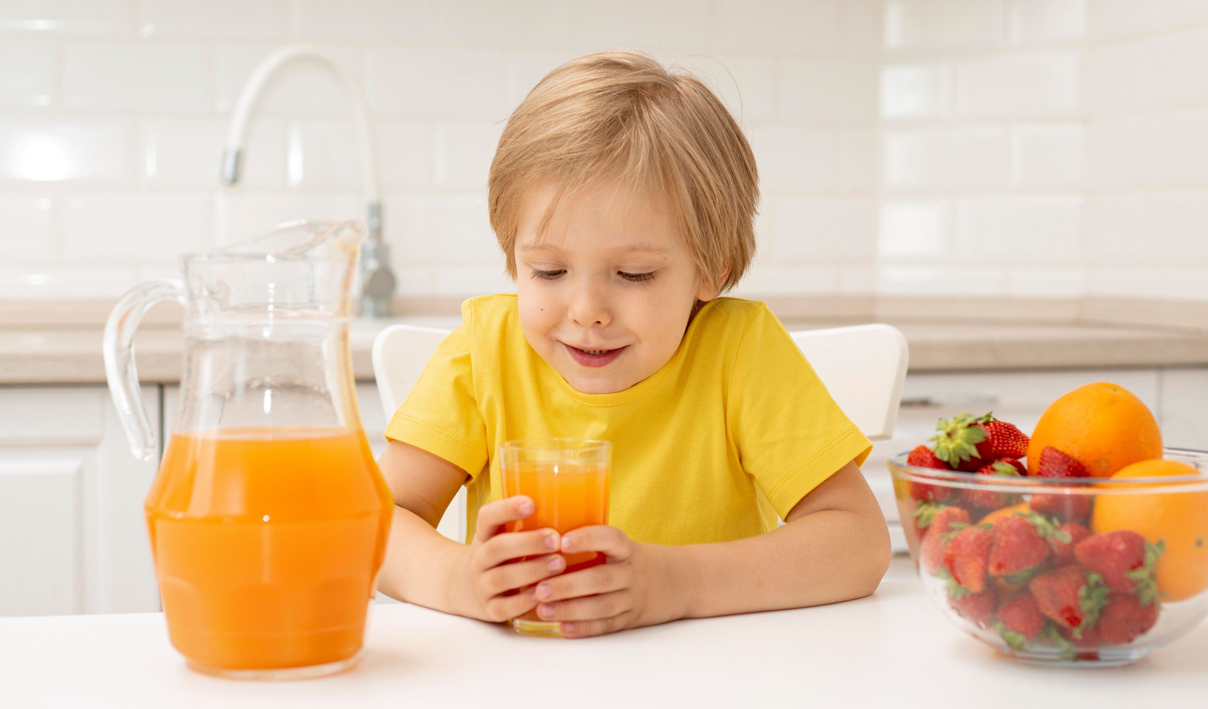 1785401655 Little Boy Home Eating Fruits Drinking Juice